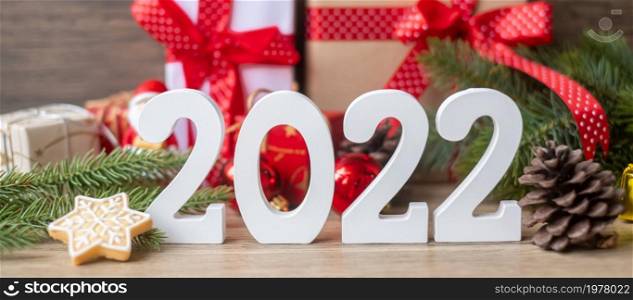 Merry Christmas and 2022 Happy New Year with decoration on table. Xmas eve, party, holiday and boxing day concept