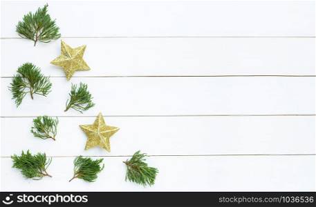 Merry Christmas and Happy Holidays, Christmas composition. golden stars, pine branches on white wooden background. Top view