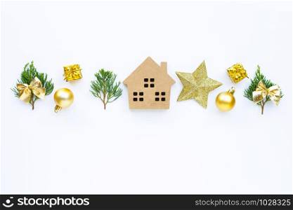 Merry Christmas and Happy Holidays, Miniature house with Christmas composition. gifts, pine branches and decorations on white background. Copy space