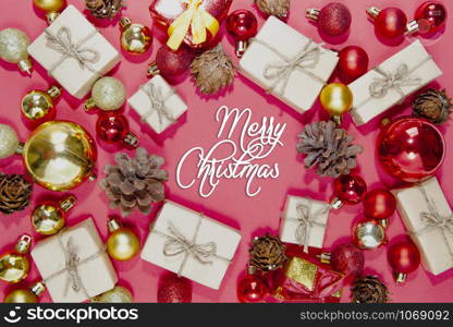 Merry Christmas and happy holidays xmas gifts. Baubles, presents, candy with christmas ornaments. Top view. Christmas family traditions on red background