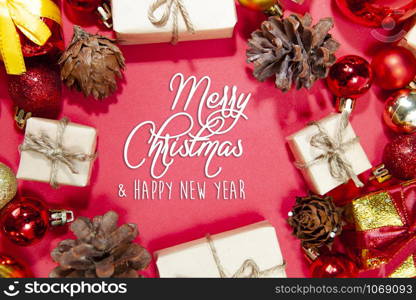 Merry Christmas and happy holidays xmas gifts. Baubles, presents, candy with christmas ornaments. Top view. Christmas family traditions on red background