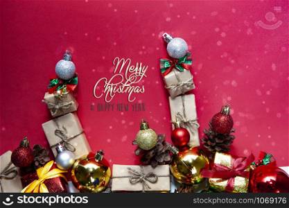 Merry Christmas and happy holidays xmas gifts. Baubles, presents, candy with christmas ornaments. Top view. Christmas family traditions on red background