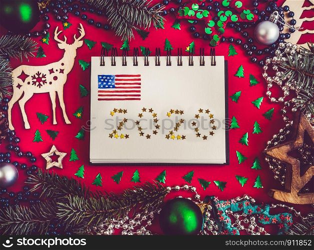 Merry Christmas and Happy New Year. Beautiful card with American flag pattern. View from above, close-up, flat lay. Congratulations to loved ones, family, relatives, friends and colleagues. Merry Christmas and Happy New Year 2020