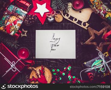 Merry Christmas and Happy New Year. Beautiful card with Christmas decorations. View from above, close-up, flat lay. Congratulations to loved ones, family, relatives, friends and colleagues. Merry Christmas. Happy New Year. Beautiful card