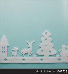 Merry Christmas and Happy New Year. Foam cutter of City with reindeers and snow boy, art and craft style on pastel color paper