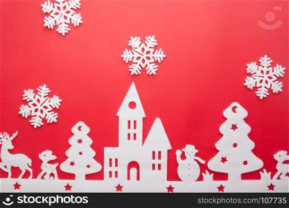 Merry Christmas and Happy New Year. Foam cutter of City with snow flake, art and craft style on red color paper