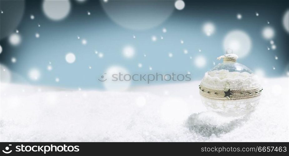 Merry Christmas and Happy New Year greeting card with ball and falling snow . Background with copy space .. Merry ball and snow