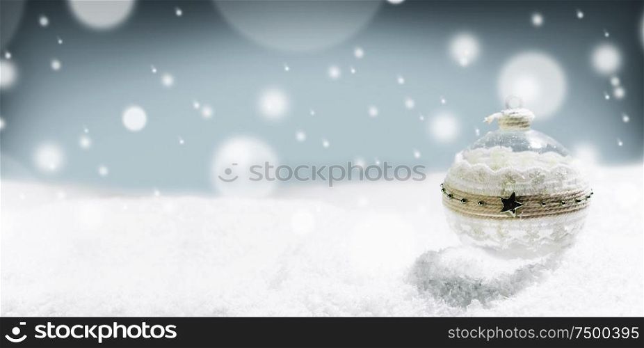 Merry Christmas and Happy New Year greeting card with ball and falling snow . Background with copy space .. Merry Christmas ball and snow