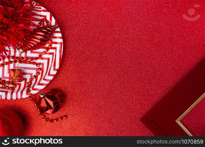 Merry christmas and happy new year red background.top view of tinsel,gift box,ball,ribbon decorate on sparkling table.holiday celebration greeting card.banner mockup for display of design
