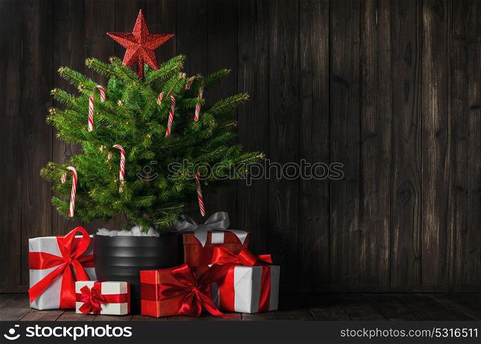 Merry christmas card. Merry christmas card with decorated christmas tree on dark wooden background