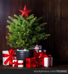 Merry christmas card with small christmas tree with star and gifts. Christmas tree and gifts