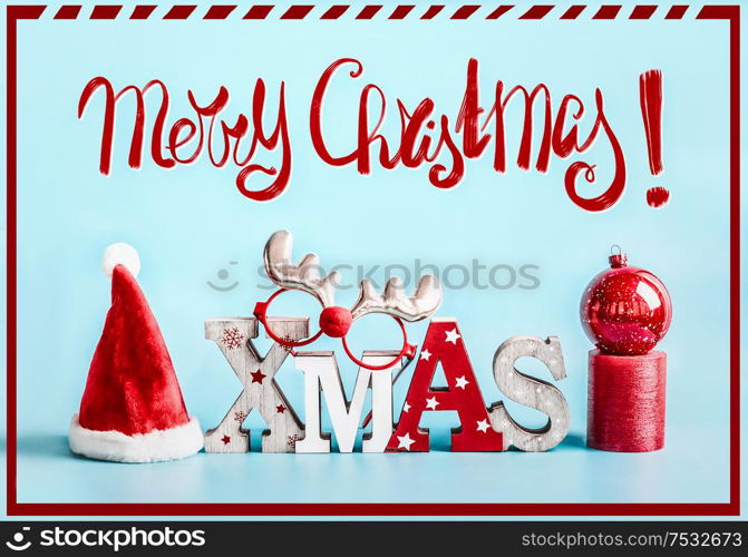 Merry Christmas greeting card with holiday decoration on blue background. Festive Xmas concept.