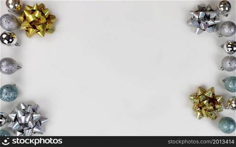 Merry Christmas or Happy New Year holiday concept with ornament and bow decorations on white background in flat lay format