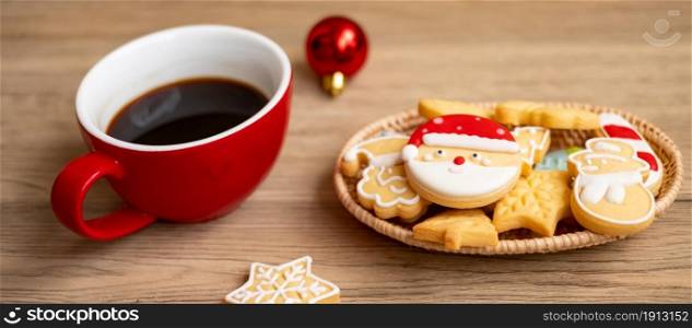 Merry Christmas with homemade cookies and coffee cup on wood table background. Xmas eve, party, holiday and happy New Year concept
