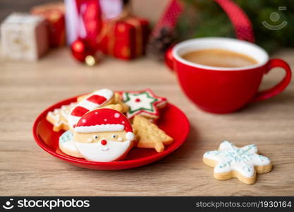 Merry Christmas with homemade cookies and coffee cup on wood table background. Xmas eve, party, holiday and happy New Year concept