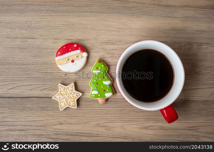 Merry Christmas with homemade cookies and coffee cup on wood table background. Xmas eve, party, holiday and happy New Year concept