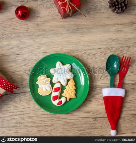 Merry Christmas with homemade cookies, fork and spoon on wood table background. Xmas, party and happy New Year concept