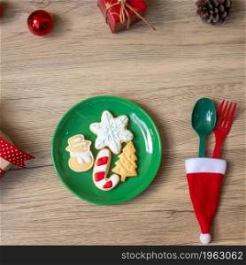Merry Christmas with homemade cookies, fork and spoon on wood table background. Xmas, party and happy New Year concept