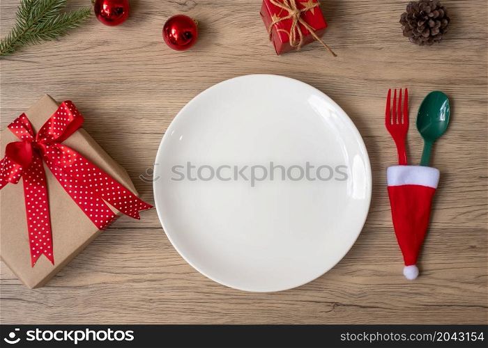Merry Christmas with plate, fork and spoon on wood table background. Xmas, party and happy New Year concept