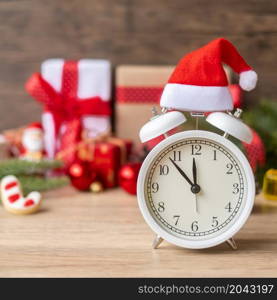 Merry Christmas with Vintage alarm clock and Xmas decoration on wooden table. party, holiday and boxing day concept