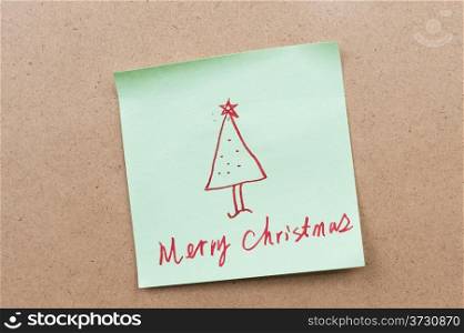 Merry Christmas words written on a sticky note
