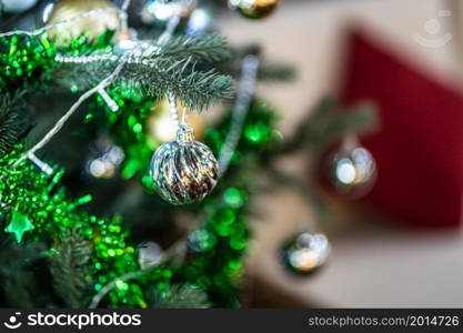 Merry x-mas,Close up of Colorful balls ,gifts box and Christmas greeting picture parcel decoration on Green Christmas tree background Decoration During Christmas and New Year.