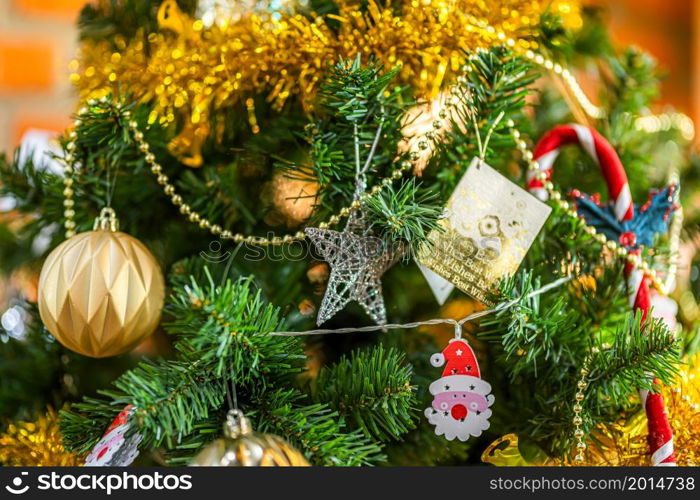 Merry x-mas,Close up of Colorful balls ,gifts box and Christmas greeting picture parcel decoration on Green Christmas tree background Decoration During Christmas and New Year.