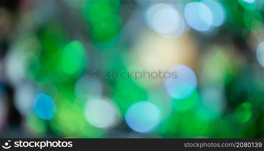 Merry x-mas,light Abstract circular bokeh of and Christmas greeting picture parcel decoration on Green Christmas tree background Decoration During Christmas and New Year.