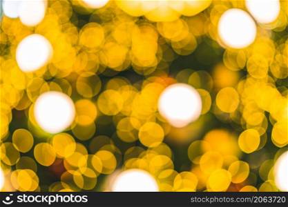 Merry x-mas,Yellow Colorful light Abstract circular bokeh of The light tunnel Christmas tree background Decoration During Christmas and New Year Festival illumination.