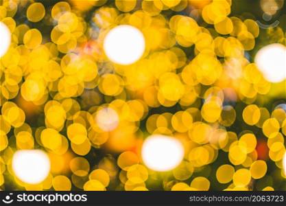 Merry x-mas,Yellow Colorful light Abstract circular bokeh of The light tunnel Christmas tree background Decoration During Christmas and New Year Festival illumination.