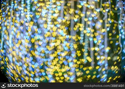 Merry x-mas,Yellow Colorful light Abstract heart bokeh of The light tunnel Christmas tree background Decoration During Christmas and Love New Year Festival illumination.