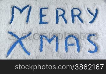 Merry Xmas drawn on snow background with matte