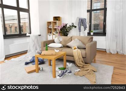 mess, disorder and interior concept - view of messy home living room with scattered stuff. interior of messy home room with scattered stuff