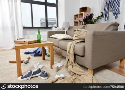 mess, disorder and interior concept - view of messy home living room with scattered stuff. messy home living room with scattered stuff