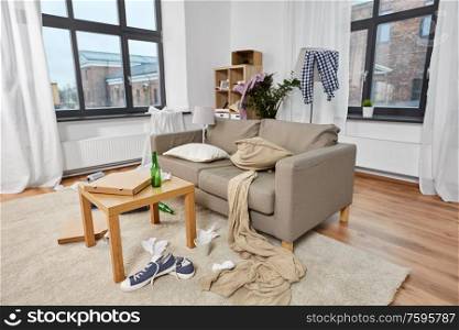 mess, disorder and interior concept - view of messy home living room with scattered stuff. messy home living room with scattered stuff