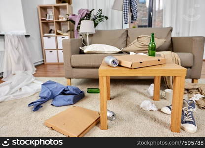 mess, disorder and interior concept - view of messy home living room with scattered stuff. messy home living room with scattered stuff