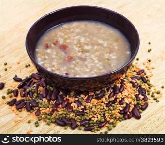 mess of pottage in bowl and beans mixture on wooden plate