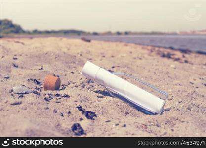 Message in a bottle on a beach in the summer