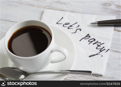 Message written on napkin. Message written on napkin and cup of coffee on wooden table