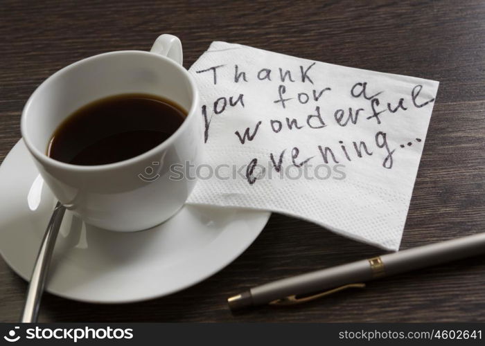 Message written on napkin. Romantic message written on napkin and cup of coffee on wooden table