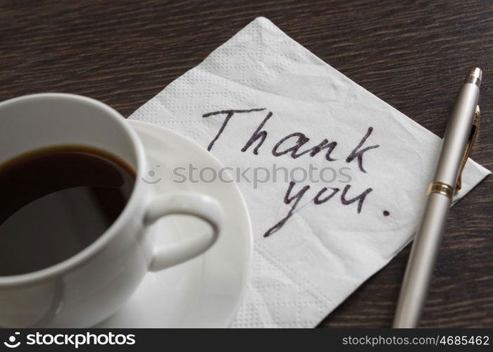 Message written on napkin. Romantic message written on napkin and cup of coffee on wooden table