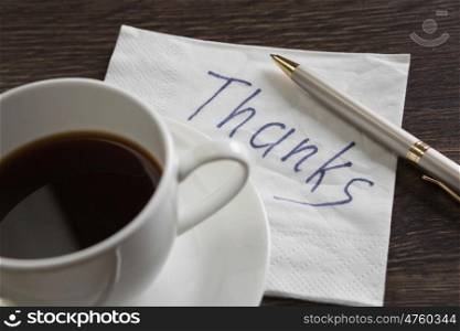 Message written on napkin. Romantic message written on napkin and cup of coffee on wooden table