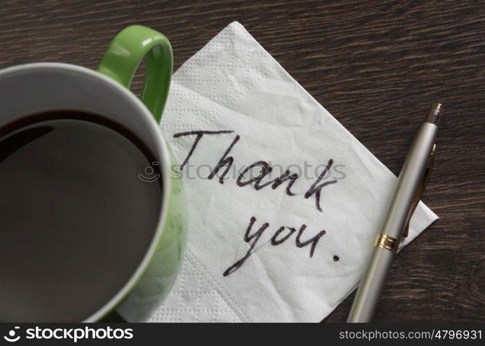 Message written on napkin. Romantic message written on napkin and cup of coffee on wooden table