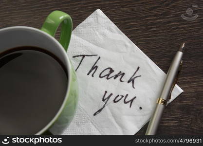 Message written on napkin. Romantic message written on napkin and cup of coffee on wooden table