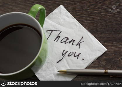 Message written on napkin. Romantic message written on napkin and cup of coffee on wooden table