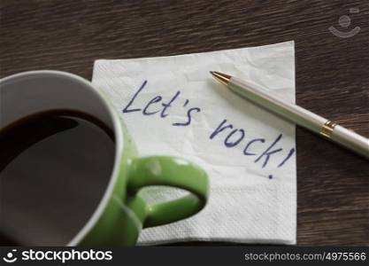 Message written on napkin. Words written on napkin and cup of coffee on wooden table