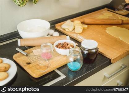 Messy kitchen with ingredients for baking lying on working table