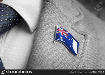 Metal badge with the flag of Australia on a suit lapel.. Metal badge with the flag of Australia on a suit lapel