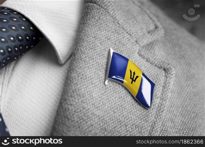 Metal badge with the flag of Barbados on a suit lapel.. Metal badge with the flag of Barbados on a suit lapel
