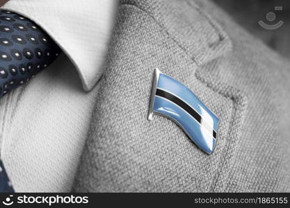 Metal badge with the flag of Botswana on a suit lapel.. Metal badge with the flag of Botswana on a suit lapel